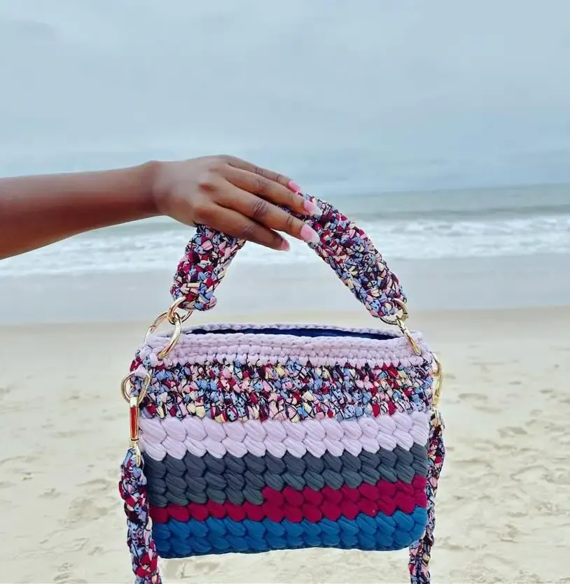 Hand holding a handmade crochet bag